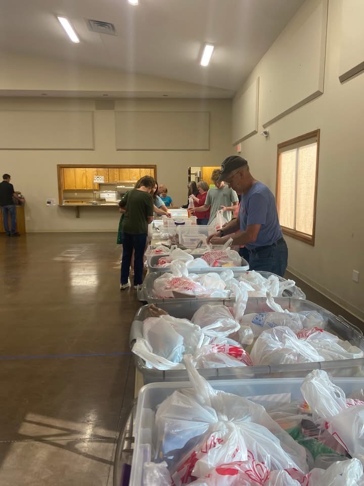 Tables lined with finished weekend care packs ready to deliver