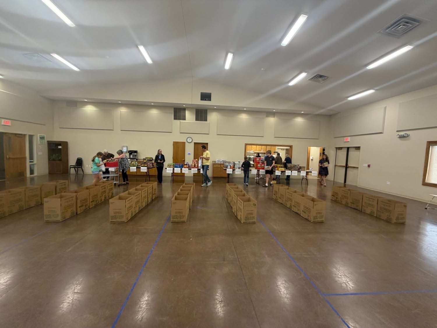 Boxes lined up on the floor ready to be filled with food
